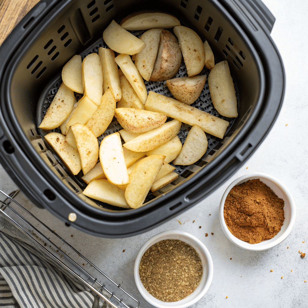 Step-By-Step Preparation Of Checkers-Style Fries: Freshly Cut Russet Potatoes, Seasoning Mix, And Air Fryer Basket Ready For Cooking.